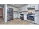 Renovated kitchen featuring stainless steel appliances, white cabinets, and hardwood floors at 921 Creekdale Dr, Clarkston, GA 30021