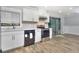 Modern kitchen with white cabinets, stainless steel appliances, and plenty of natural light at 921 Creekdale Dr, Clarkston, GA 30021