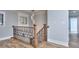 Bright upstairs landing with hardwood floors, windows, decorative wrought iron railing and modern lighting at 921 Creekdale Dr, Clarkston, GA 30021