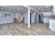 Spacious living area featuring hardwood floors, modern lighting, and an open floor plan to the kitchen at 921 Creekdale Dr, Clarkston, GA 30021