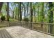 Large back deck overlooking a beautiful, lush green backyard with mature trees and natural surroundings at 3309 Poplar Dr, Lawrenceville, GA 30044