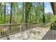 Spacious back deck offering serene views of the lush backyard with mature trees and surrounding nature at 3309 Poplar Dr, Lawrenceville, GA 30044
