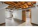 Unfinished basement featuring exposed ceiling, concrete flooring, and a doorway leading to another unfinished area at 3309 Poplar Dr, Lawrenceville, GA 30044
