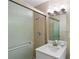 Bathroom featuring glass-enclosed shower, modern vanity with decorative lights, and neutral tile at 3309 Poplar Dr, Lawrenceville, GA 30044