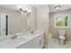Bathroom features double sinks, quartz countertops, decorative lighting, and tile flooring at 3309 Poplar Dr, Lawrenceville, GA 30044