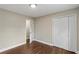 Bedroom with wood floors offers closet, neutral paint, and easy access to adjoining room at 3309 Poplar Dr, Lawrenceville, GA 30044