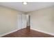 Comfortable bedroom with wood floors provides closet and convenient doorway to another room at 3309 Poplar Dr, Lawrenceville, GA 30044