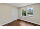 Bedroom features wood floors, a closet, natural light from the window, and neutral paint at 3309 Poplar Dr, Lawrenceville, GA 30044