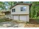 A view of the home's front, highlighting the convenient two-car garage and the surrounding greenery at 3309 Poplar Dr, Lawrenceville, GA 30044