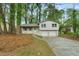 Charming home features a front yard with mature trees and a two-car garage, offering both curb appeal and functionality at 3309 Poplar Dr, Lawrenceville, GA 30044
