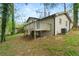 Back exterior view of the home featuring a deck and brick foundation at 3309 Poplar Dr, Lawrenceville, GA 30044