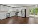 Modern kitchen featuring white cabinets, stainless steel appliances, and a convenient sliding door to the outdoors at 3309 Poplar Dr, Lawrenceville, GA 30044