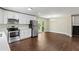 An open kitchen with stainless steel appliances, white cabinets, and hardwood floors providing both style and functionality at 3309 Poplar Dr, Lawrenceville, GA 30044