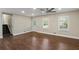 Inviting living room with hardwood floors and bright windows offers a comfortable and stylish living space at 3309 Poplar Dr, Lawrenceville, GA 30044