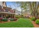 Backyard with green grass, retaining wall, plants and stairs to the deck at 4155 Summit Gate Dr, Suwanee, GA 30024
