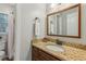 Bathroom featuring a wooden framed mirror and granite countertop vanity at 4155 Summit Gate Dr, Suwanee, GA 30024