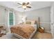 Comfortable bedroom with neutral walls, hardwood floors, and a ceiling fan at 4155 Summit Gate Dr, Suwanee, GA 30024