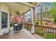 Covered deck featuring an outdoor dining set, curtains and view of the backyard at 4155 Summit Gate Dr, Suwanee, GA 30024
