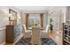Elegant dining room with hardwood floors, wainscoting, and traditional furnishings at 4155 Summit Gate Dr, Suwanee, GA 30024