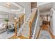 Light-filled foyer with staircase, hardwood floors, and elegant decor at 4155 Summit Gate Dr, Suwanee, GA 30024