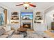 Comfortable living room featuring a cozy fireplace and custom built-in shelving at 4155 Summit Gate Dr, Suwanee, GA 30024