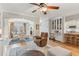 Spacious living area with hardwood floors, ceiling fan, and seamless flow to the dining area at 4155 Summit Gate Dr, Suwanee, GA 30024