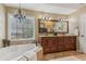 The main bathroom features a double sink vanity, soaking tub, and a chandelier at 4155 Summit Gate Dr, Suwanee, GA 30024