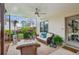 Covered patio featuring a loveseat, two wicker chairs, and a view of the landscaped yard at 4155 Summit Gate Dr, Suwanee, GA 30024