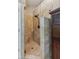 The tiled shower includes a built-in seat and seamless glass doors at 4155 Summit Gate Dr, Suwanee, GA 30024