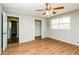 Bright bedroom featuring hardwood floors, ceiling fan, walk-in closet, and neutral paint at 5798 Salem Rd, Covington, GA 30016