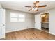 Neutral bedroom with hardwood floors, a ceiling fan, and access to a bathroom at 5798 Salem Rd, Covington, GA 30016