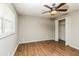 Neutral bedroom with hardwood flooring, a ceiling fan and double door closet at 5798 Salem Rd, Covington, GA 30016