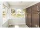 Bright sun room featuring large windows, tile floors and built in cabinets at 5798 Salem Rd, Covington, GA 30016