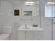 A clean, all-white bathroom with modern fixtures, a large mirror, and a glass-enclosed shower at 1211 Oakdale Ne Rd, Atlanta, GA 30307