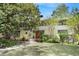 Charming home featuring mature trees, manicured landscaping, and a welcoming front entrance at 1211 Oakdale Ne Rd, Atlanta, GA 30307