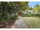 Beautiful home featuring an immaculate lawn, mature trees, and a stone walkway leading to the front door at 1211 Oakdale Ne Rd, Atlanta, GA 30307