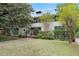 Elegant front exterior featuring a well-maintained lawn and mature shade trees and bushes at 1211 Oakdale Ne Rd, Atlanta, GA 30307