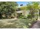 Attractive home exterior featuring a well-kept lawn and mature shade trees at 1211 Oakdale Ne Rd, Atlanta, GA 30307