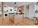 Open concept kitchen with a large island, hardwood floors, and modern light fixtures at 1211 Oakdale Ne Rd, Atlanta, GA 30307
