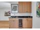 Wet bar features dark counters, built in beverage cooler, and light wood cabinets at 1211 Oakdale Ne Rd, Atlanta, GA 30307