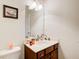 Classic bathroom design with a wood vanity, framed mirror, and soft lighting at 1250 Edgebrook Ln, Snellville, GA 30078