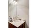 Bathroom with a sink, dark brown wood cabinet, and a big mirror at 1250 Edgebrook Ln, Snellville, GA 30078
