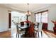 Elegant dining room featuring a marble table, stylish chandelier, and seamless access to the living room at 1250 Edgebrook Ln, Snellville, GA 30078