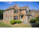 Stunning two-story brick home showcasing detailed architecture, manicured lawn, and inviting curb appeal at 1250 Edgebrook Ln, Snellville, GA 30078