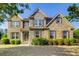 Charming two-story home with brick and stone facade, landscaped front yard, and inviting entrance at 1250 Edgebrook Ln, Snellville, GA 30078