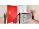 Bright hallway featuring a vibrant red wall, staircase, and a decorative vase with foliage at 1250 Edgebrook Ln, Snellville, GA 30078