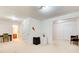 Spacious living room with neutral carpet, mini fridge, and access to other rooms, suitable for entertaining at 1250 Edgebrook Ln, Snellville, GA 30078