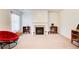 Cozy living room featuring a fireplace, built-in shelving, and a comfortable red papasan chair at 1250 Edgebrook Ln, Snellville, GA 30078