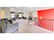 Spacious living room with lots of light, featuring comfortable seating and a staircase with a bright red wall at 1250 Edgebrook Ln, Snellville, GA 30078
