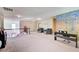 Open living area featuring comfortable armchairs, a piano, and staircase with wooden railings at 1250 Edgebrook Ln, Snellville, GA 30078
